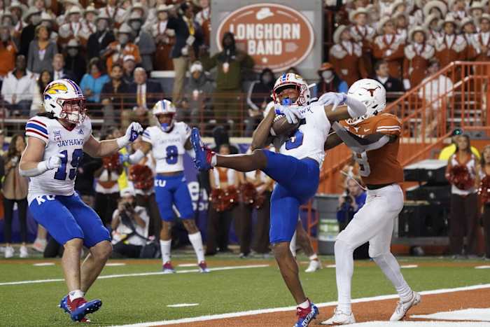 Nov 13, 2021; Austin, Texas, USA; Kansas Jayhawks safety OJ Burroughs (5) intercepts a pass in the end zone intended for Texas Longhorns wide receiver Xavier Worthy (8) in the second half at Darrell K Royal-Texas Memorial Stadium.